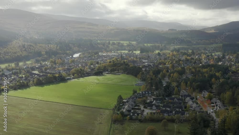 Aerial view of the Scottish town of Ballater in the Cairngorms National Park, Aberdeenshire. Flying towards the town across fields with zoom in. Aerial view of the Scottish town of Ballater in the Cairngorms National Park, Aberdeenshire. Flying towards the town across fields with zoom in.