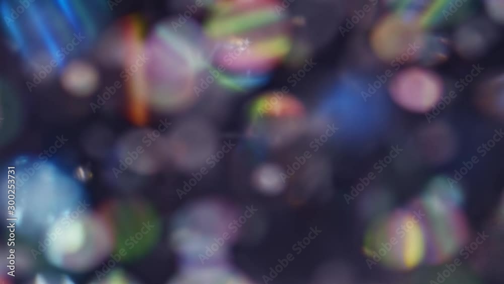 Glittering lights in a rainbow of colors in blurry bokeh abstract background
