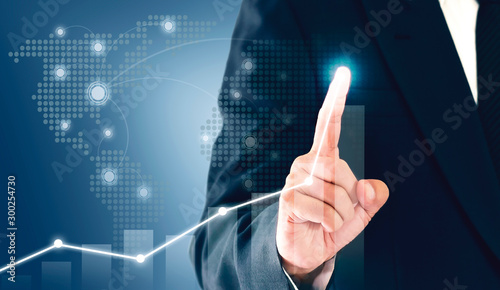 Businessman showing business growth on a chart, hands touch the graph that represents profit rises on a lot more.