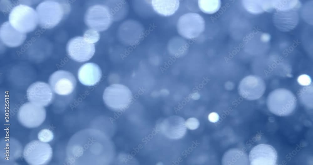 Glittering blue lights in blurry bokeh background Glittering blue lights in blurry bokeh background