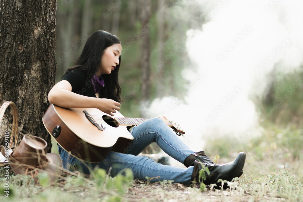 custom made wallpaper toronto digitalAsia woman playing the guitar with loneliness and sadness.heartbroken woman concept.