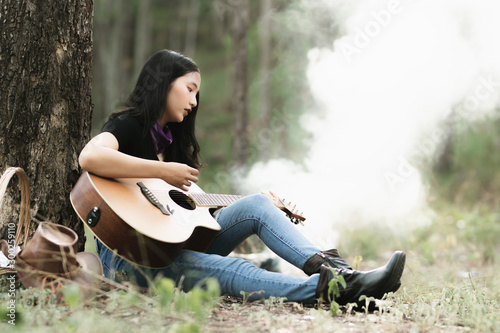 Wallpaper Mural Asia woman playing the guitar with loneliness and sadness.heartbroken woman concept. Torontodigital.ca