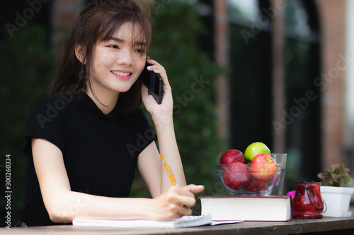 Asia woman using smartphone working ,playing in free time with fun and happy. photo