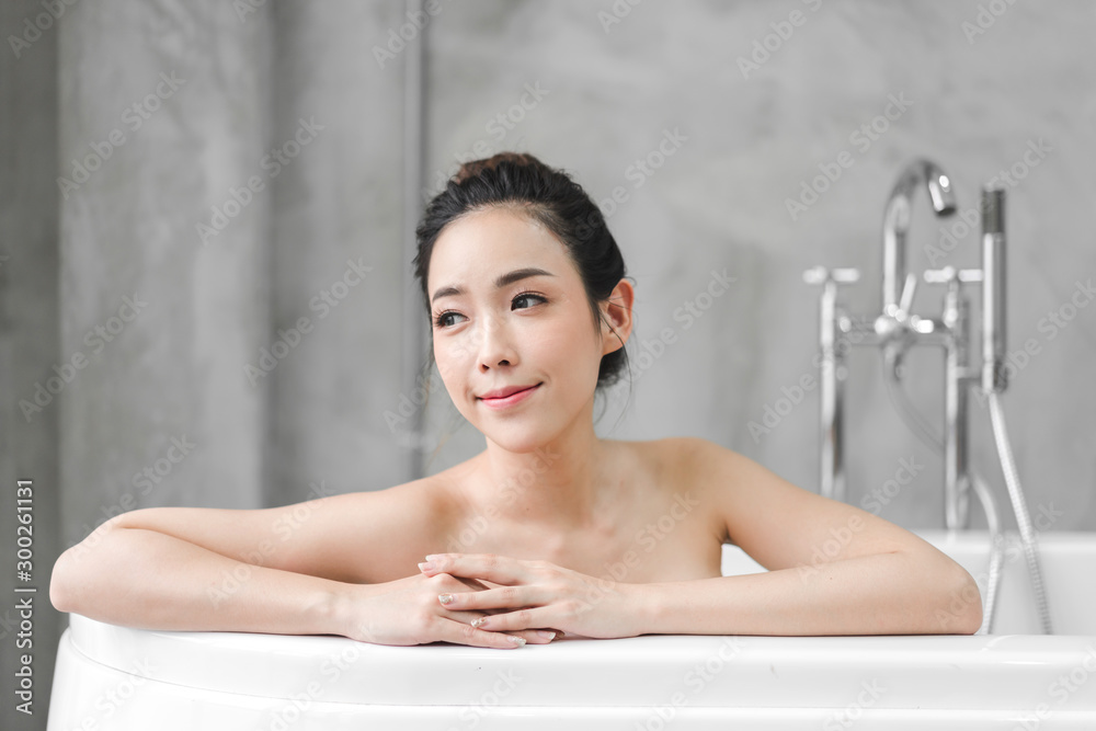 Beautiful young asia woman enjoy relaxing taking a bath with bubble foam in bathtub at the bathroom Beautiful young asia woman enjoy relaxing taking a bath with bubble foam in bathtub at the bathroom