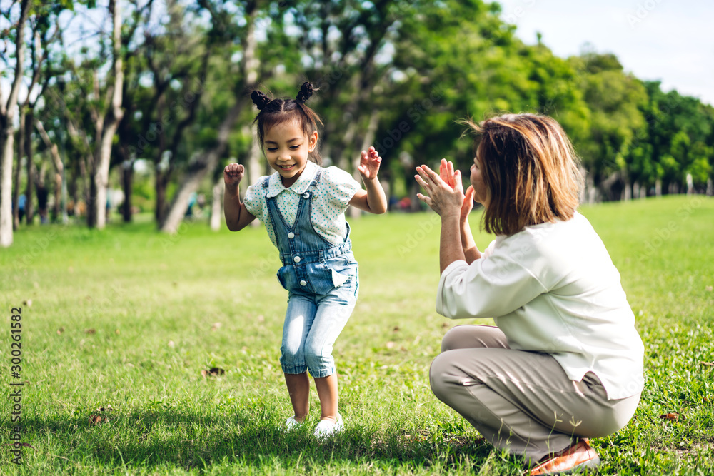 Portrait of happy grandmother and little cute girl enjoy relax together in summer park.Family and togetherness Portrait of happy grandmother and little cute girl enjoy relax together in summer park.Family and togetherness