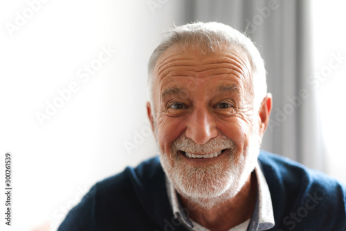 Portrait of happy smiling senior man looking at camera