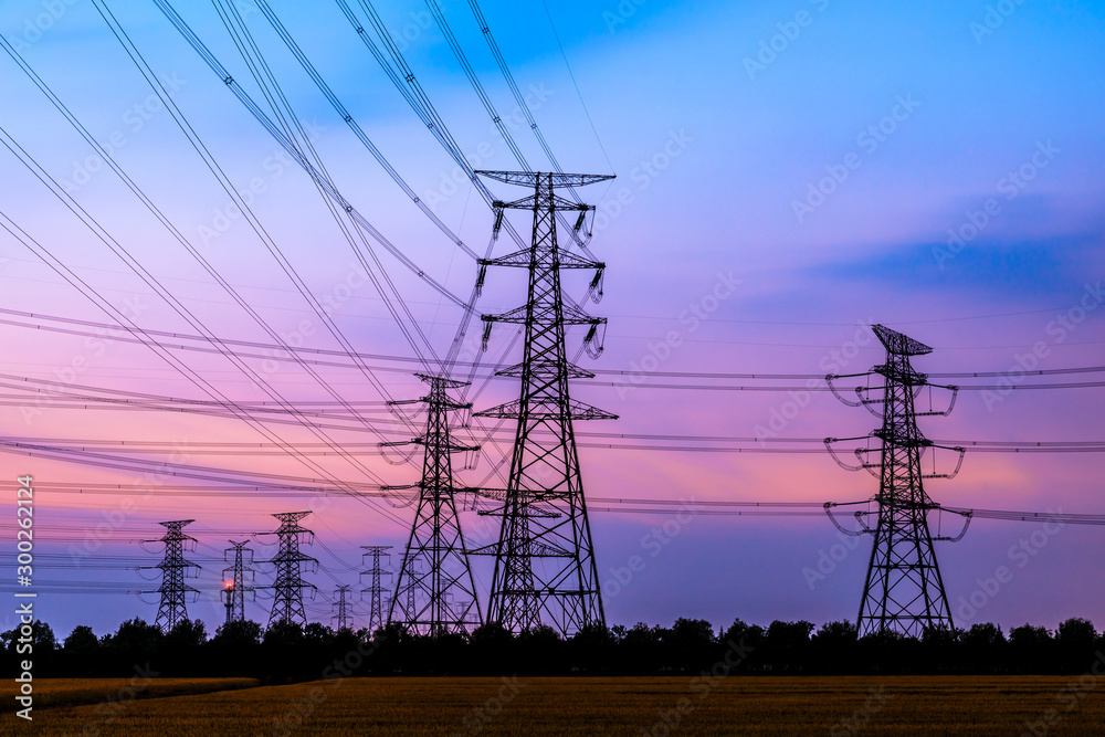 Fototapeta premium Electricity tower silhouette and sky landscape at dusk