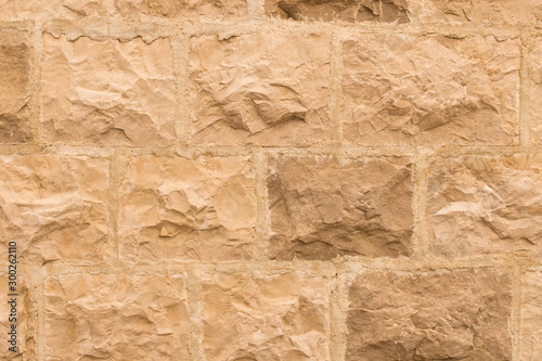 Background texture of the old fortress stone wall. Conceptual background for designers. Selective focus.