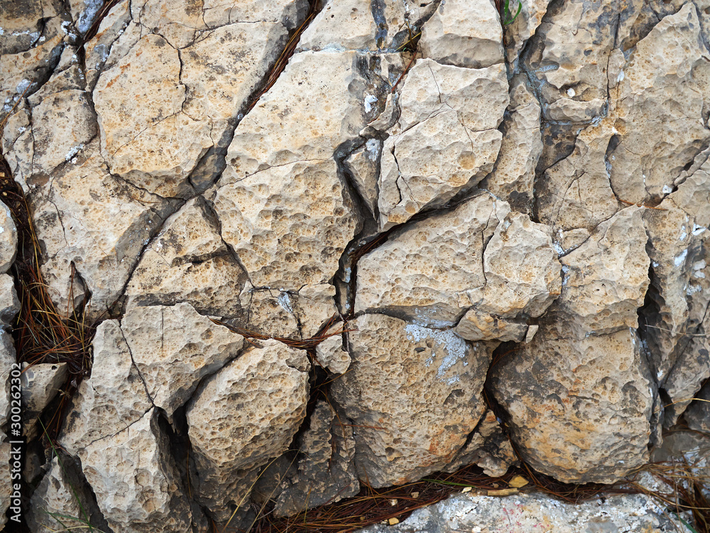 Cracked aged mountain hard rock stones