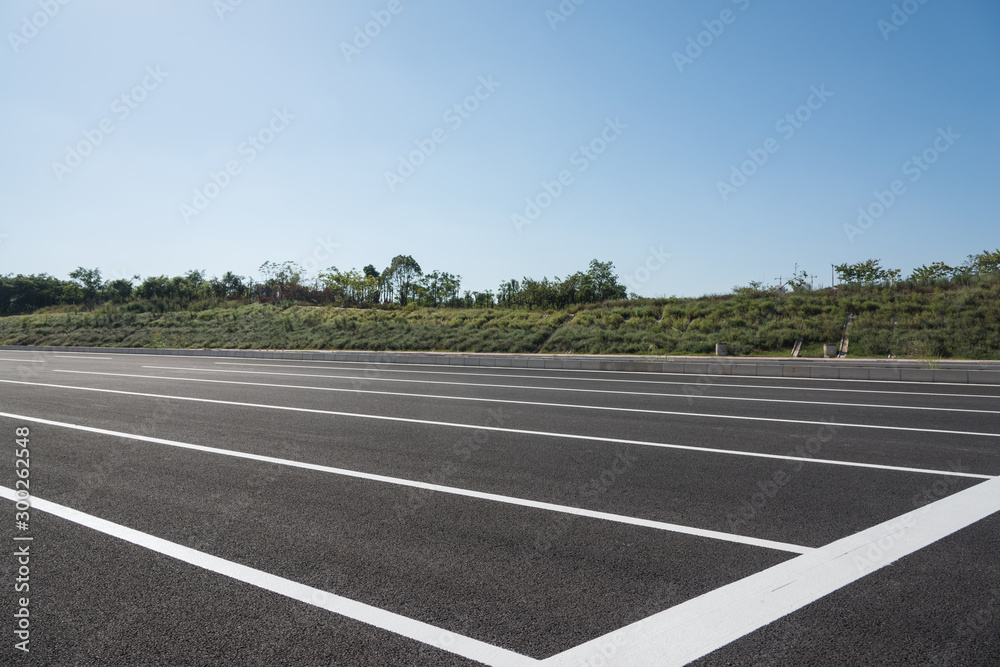 New asphalt pavement and white paint line low angle space