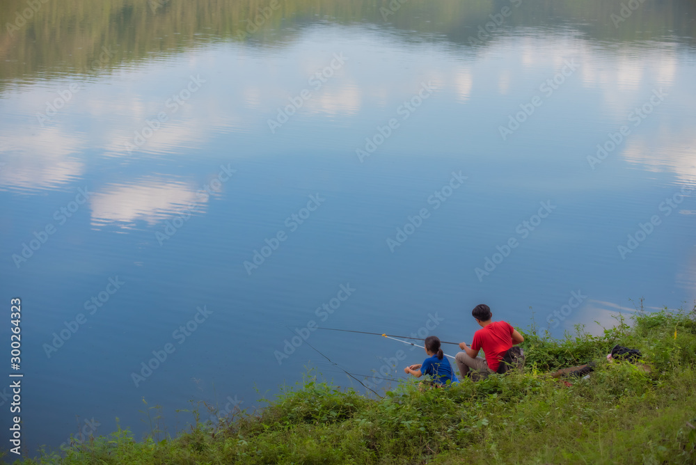Fishing at the reservoir under the clear sky..