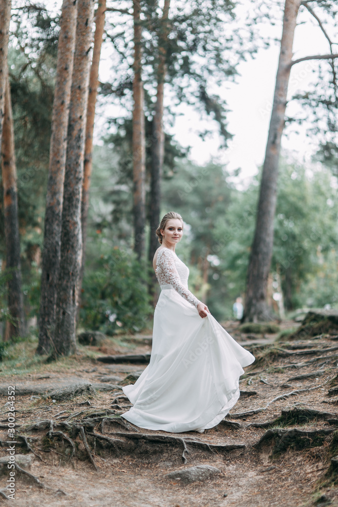 Elegant ceremony in European style. Beautiful bride in white flying dress in the forest. Elegant ceremony in European style. Beautiful bride in white flying dress in the forest.