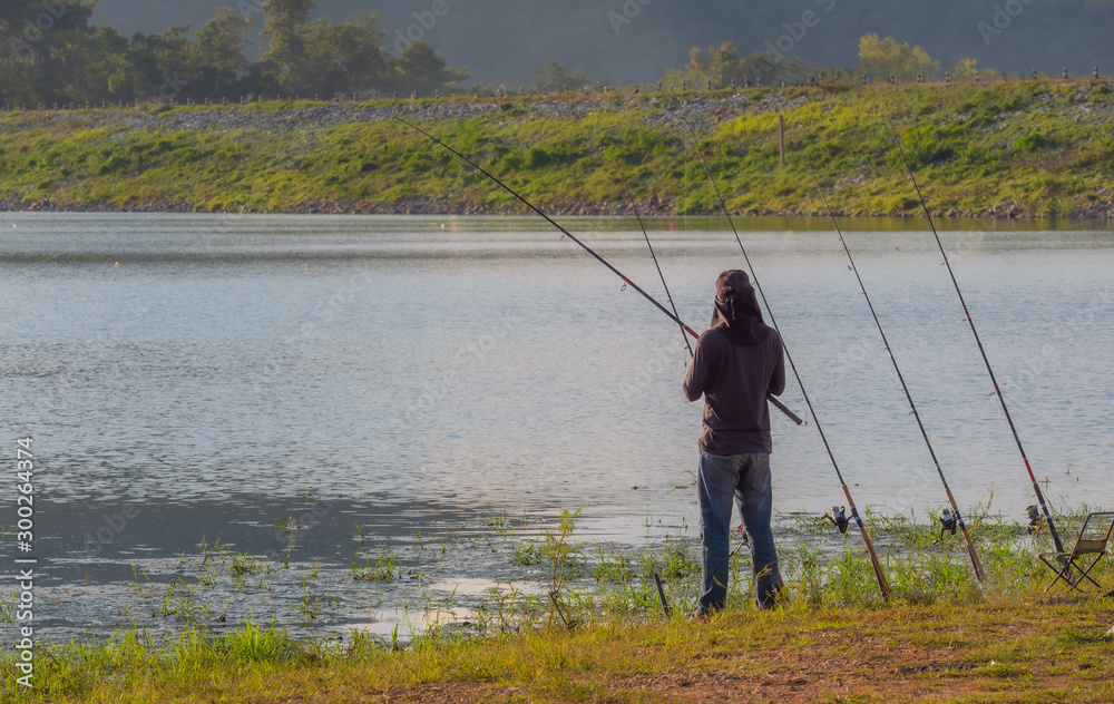Fishing at the reservoir under the clear sky.. Fishing at the reservoir under the clear sky..