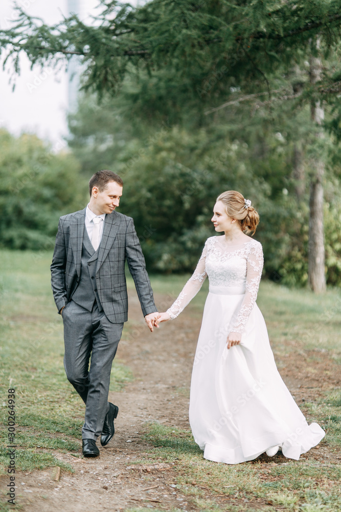 Modern ceremony in European style. Beautiful wedding couple in atmospheric forest with rocks.