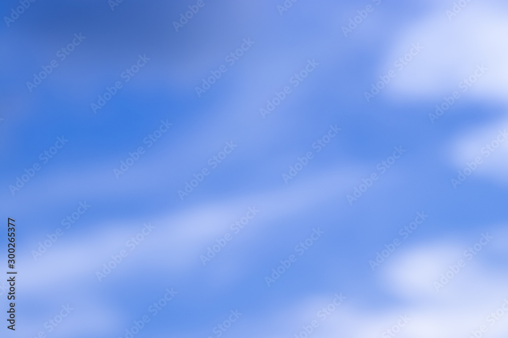 Abstract blurred background Blue sky with white clouds in sunlight.