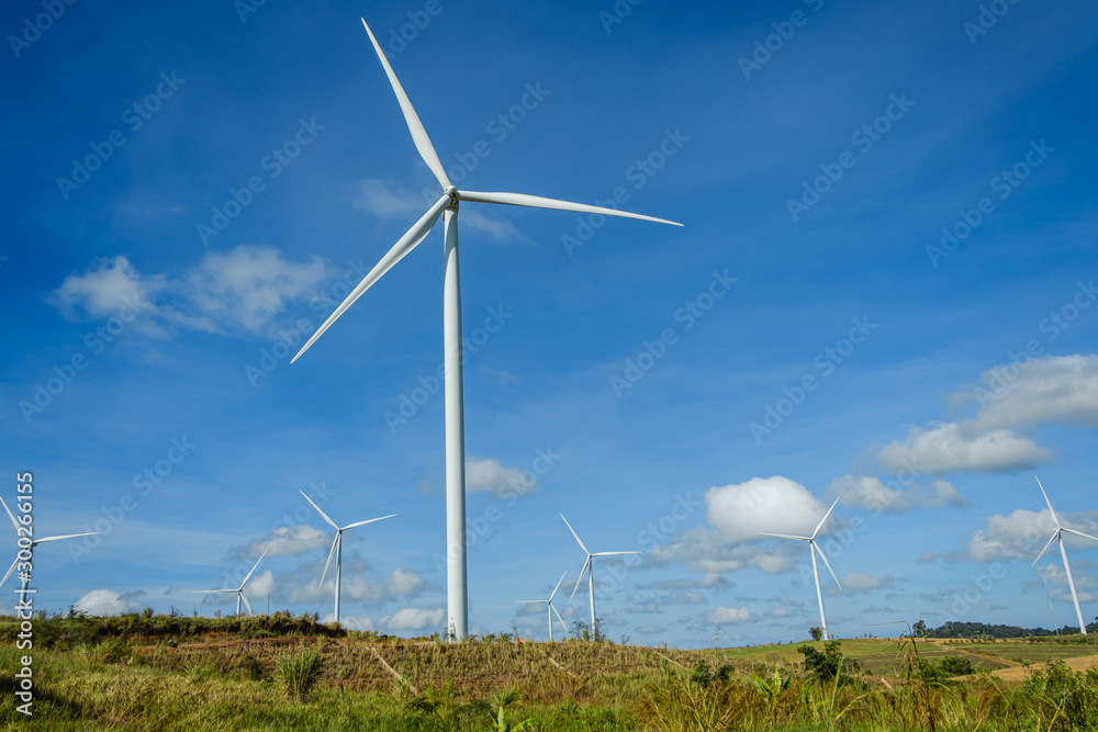 Wind turbines generating electricity with blue sky background,from wind power for environmental Wind turbines generating electricity with blue sky background,from wind power for environmental