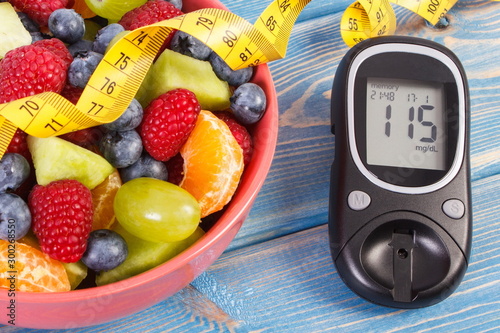 Fresh fruit salad, glucometer and centimeter, diabetes, healthy lifestyle and nutrition concept