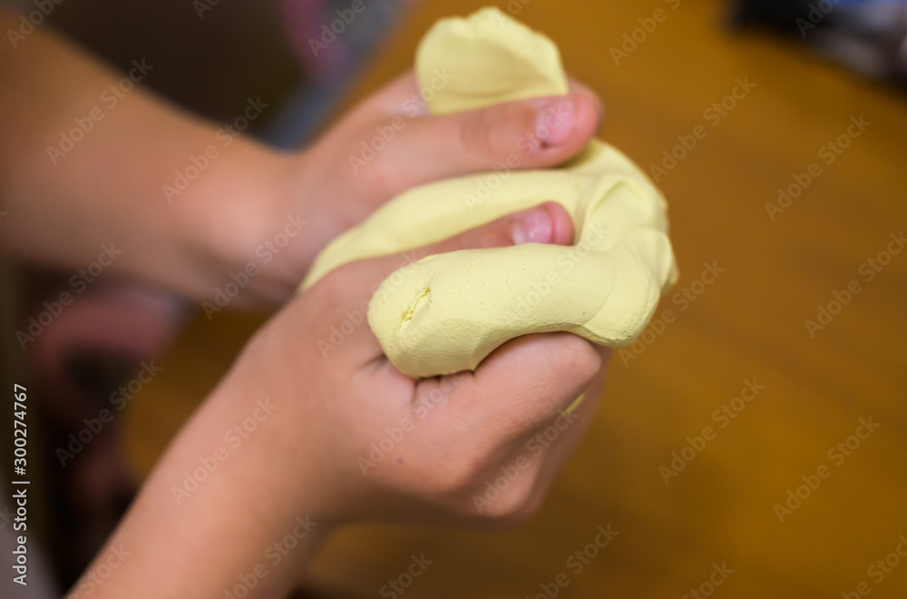 Little girl plays with toy called slime at home. Selective focus. Little girl plays with toy called slime at home. Selective focus.