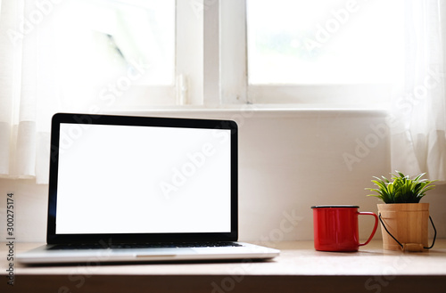 blank screen Modern laptop computer on wood table in Home office view backgrounds