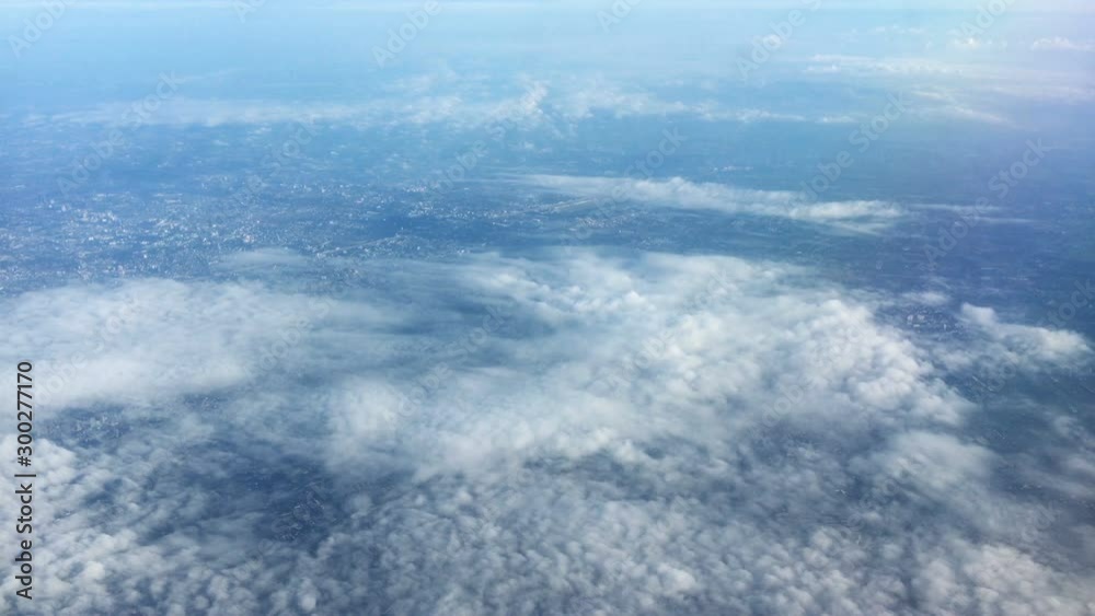 The cloud over the mountain look through plane window view flying high, bird eye view The cloud over the mountain look through plane window view flying high, bird eye view
