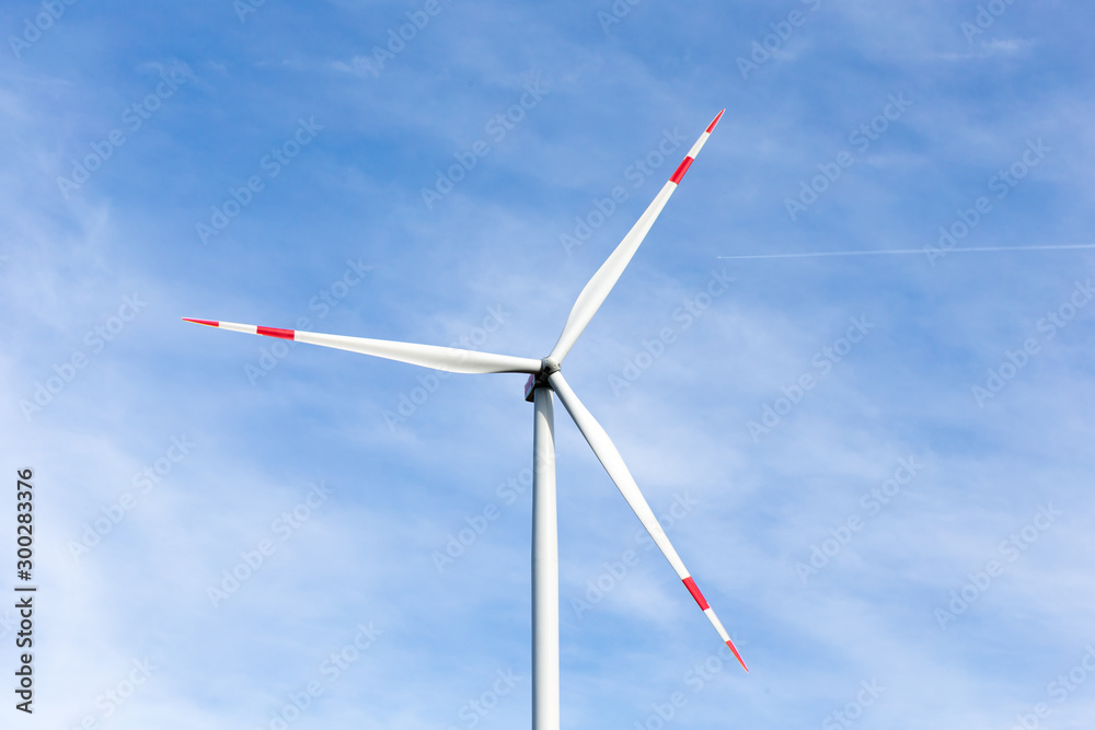 A windmill with a blue sky in the background A windmill with a blue sky in the background