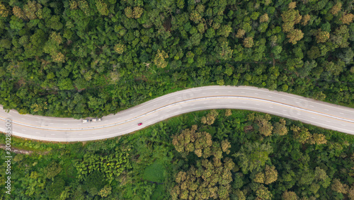 Fototapeta Naklejka Na Ścianę i Meble -  Aerial top view of pathway road in forest, view from drone