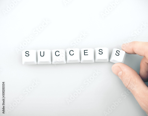 hand folds the word success