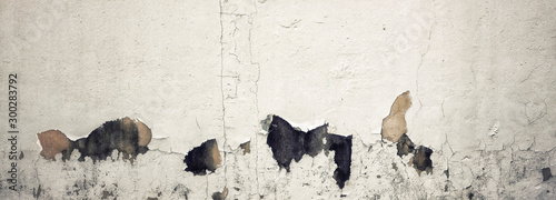 Old Wall with Moldy Peeling White Painting from Humidity. Cracked White Wall as Rusty Concrete Weathered Wall Grunge Background or Abstract Backdrop Wallpaper Vintage Texture Design Copy Space Text