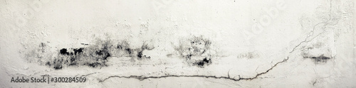 Old Wall with Moldy Peeling White Painting from Humidity. Cracked White Wall as Rusty Concrete Weathered Wall Grunge Background or Abstract Backdrop Wallpaper Vintage Texture Design Copy Space Text