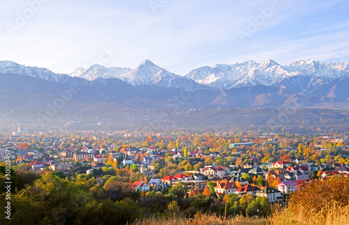 Panoramic view of the upper part of Almaty city on the background of mountains in autumn season; golden fall, beauty and greatness of Kazakhstan concept photo