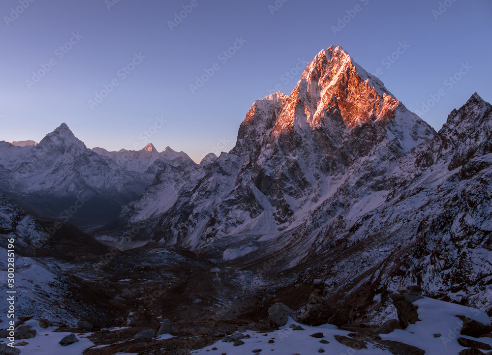 Majestic mountain peaks at sunrise in Nepal, Himalayas; cloudless sky, the first rays of the sun, the beginning of a perfect day