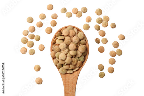 Foto Pile lentil in wooden spoon isolated on white background