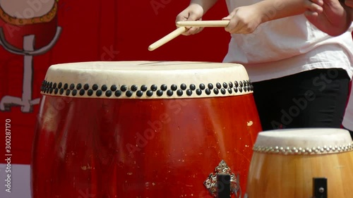 drummer playing big red drum photo