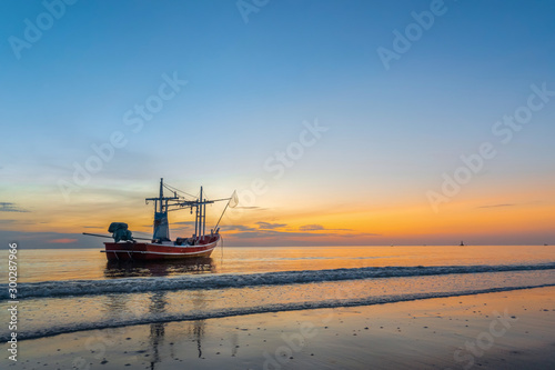Tablou canvas Fishing vessel with sea ocean in sunrise time.