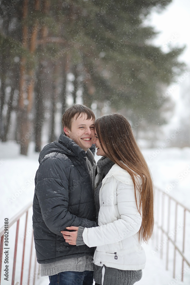 Fototapeta premium pair of lovers on a date winter afternoon in a snow blizzard