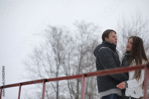 pair of lovers on a date winter afternoon in a snow blizzard