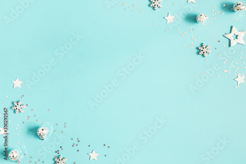 Christmas composition. Silver decorations on pastel blue background. Christmas, winter, new year concept. Flat lay, top view, copy space