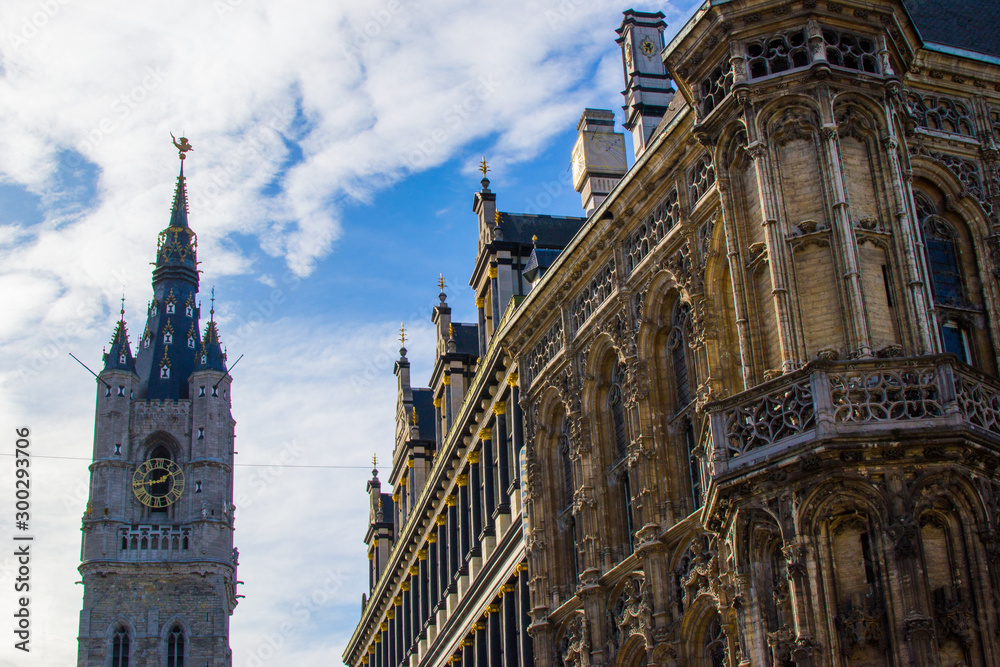 Fototapeta premium View of the Town Hall of Ghent, Belgium, Europe, on the right side and the Belfry (Bell tower) at the background