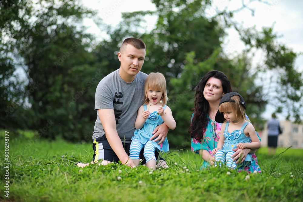Fototapeta premium Mom with two daughters twins