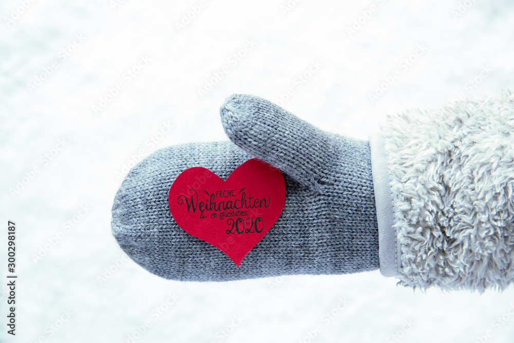 Red Heart With German Calligraphy Frohe Weihnachten Und Ein Glueckliches 2020 Means Merry Christmas And A Happy 2020. Hand In A Glove With Fleece And Snow.