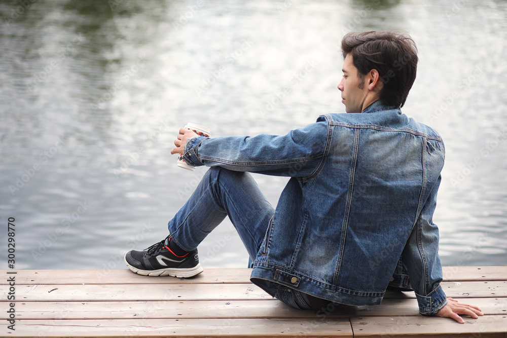 A young man walks in the park at lunch time. A man is on a walk in the city. A student in the park. A young man walks in the park at lunch time. A man is on a walk in the city. A student in the park.