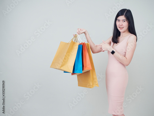 Smiling beauty woman with colorful shopping bags