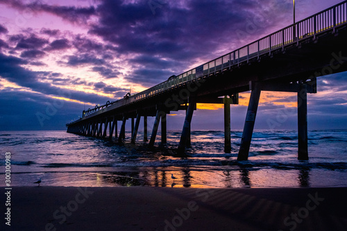 Jetty at sunrise with dramatic clouds © Kylie