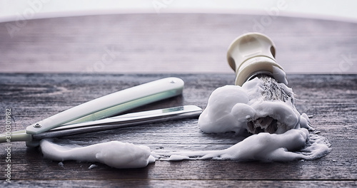 Fotografie Shaving accessories on a wooden texture background