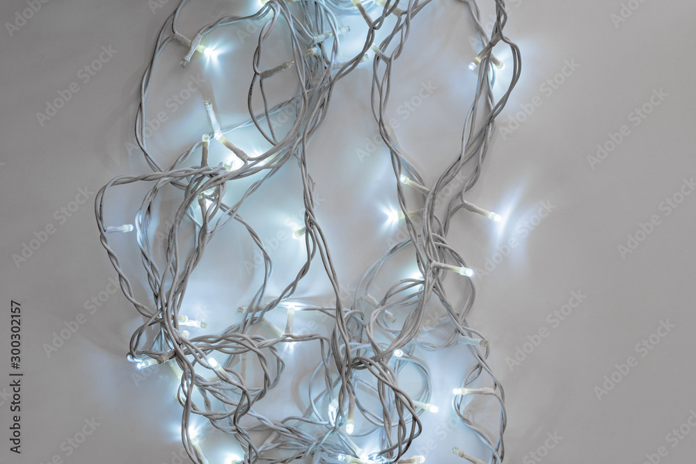 Cold lights illuminated garland on gray background Cold lights illuminated garland on gray background