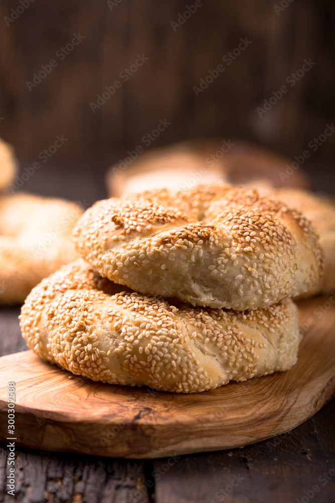 Greek koulouri or Turkish bagels called Simit in stack. Traditional street food, crispy sesame bread ring bagels