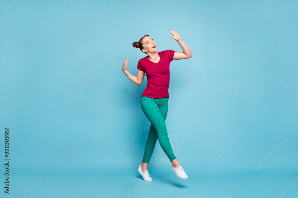 Fototapeta premium Full length body size photo of cheerful positive cute nice charming attractive girlfriend wearing green pants trousers white footwear dancing stepping isolated pastel color background