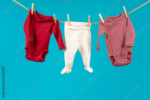 Clothesline with pinned baby clothes close up