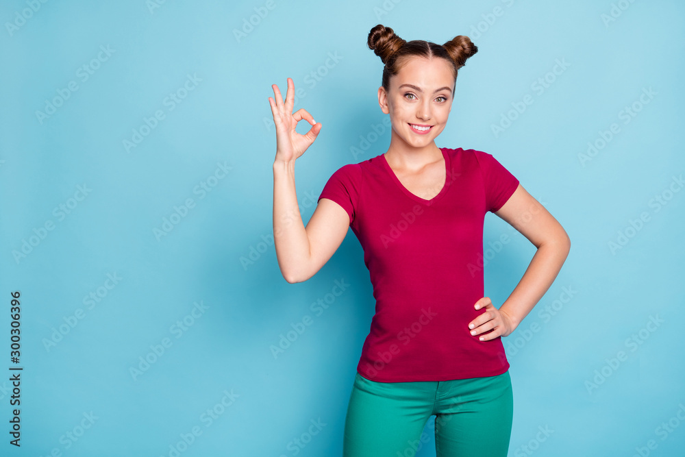 Photo of cheerful positive cute nice pretty charming teen showing you ok sign with hands confident on waist in pants trousers isolated pastel blue color background Photo of cheerful positive cute nice pretty charming teen showing you ok sign with hands confident on waist in pants trousers isolated pastel blue color background