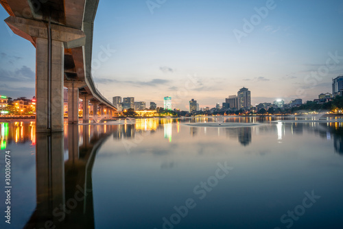 Hanoi cityscape at twilight at Hoang Cau lake  with the Cat Linh-Ha Dong elevated railroad